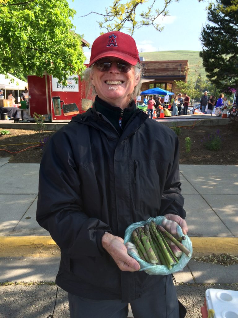 A vendor offers fresh asparagus in spring